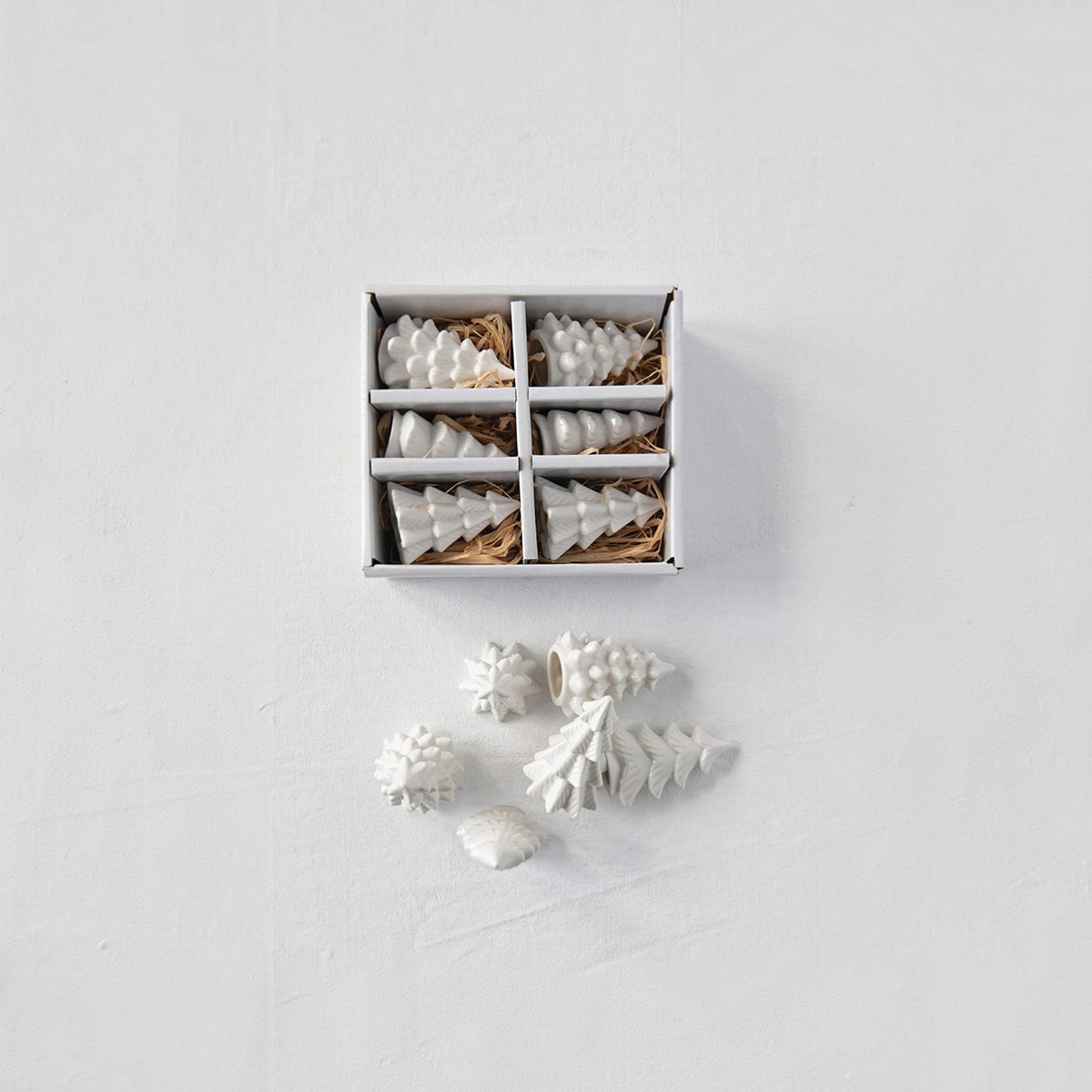 Mellow Monkey set of six small white stoneware Christmas trees in a gift box for holiday mantel and table decor.