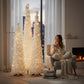 Mellow Monkey white tinsel collapsible Christmas trees in various heights illuminated in a cozy living room setting.