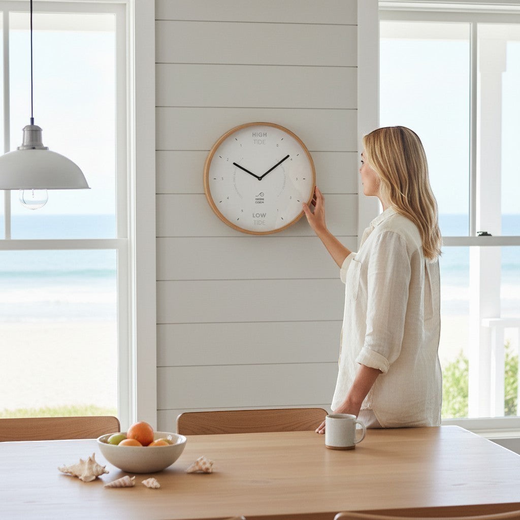 Mellow Monkey 12-inch white wood tide clock with a natural beech frame, white hands, and mineral glass face. Displays hours until high and low tide.