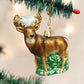 Mellow Monkey Whitetail Deer blown glass holiday ornament with gold antlers and glitter accents, standing on green grass.