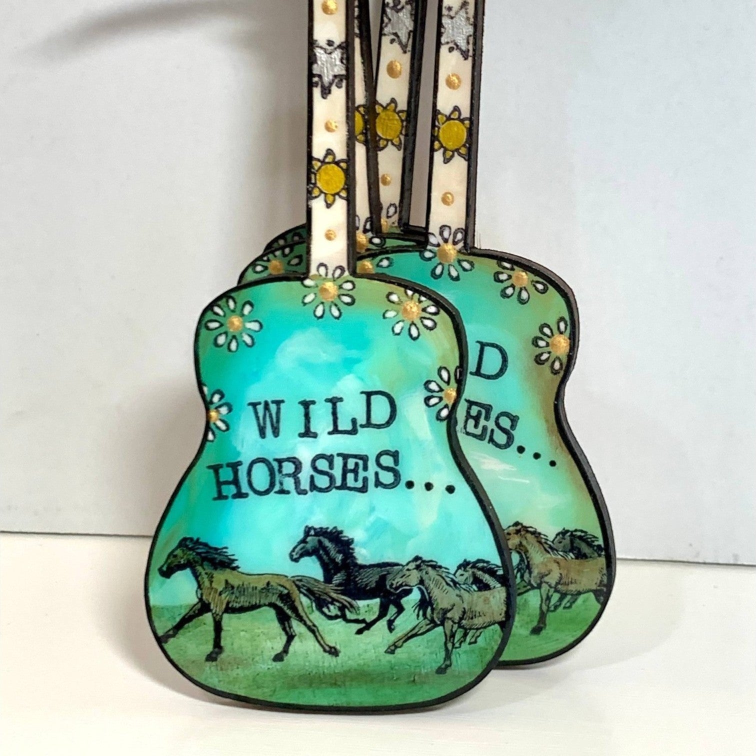 Mellow Monkey Rolling Stones Wild Horses guitar ornament featuring hand-painted green horses and floral details.