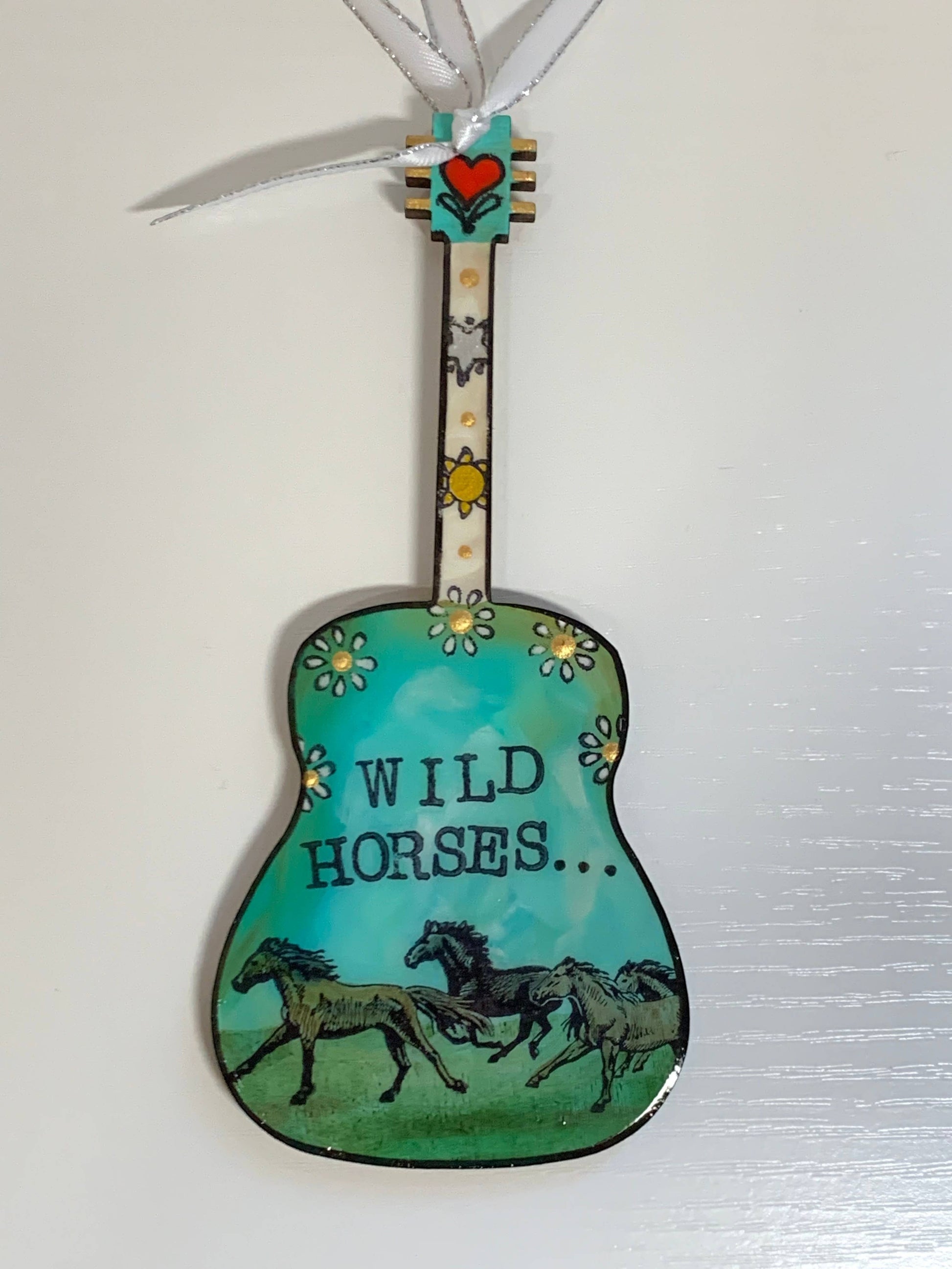 Mellow Monkey hand-painted guitar ornament featuring Wild Horses artwork with a teal background and white ribbon.