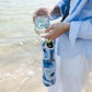 Mellow Monkey Ebb and Flow wine tote in blue and white neoprene, featuring Kim Hovell art. Holds a wine bottle.