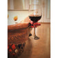 Mellow Monkey red wineGrasp wine glass holder clipped to the edge of a wooden pool table holding a glass of red wine.
