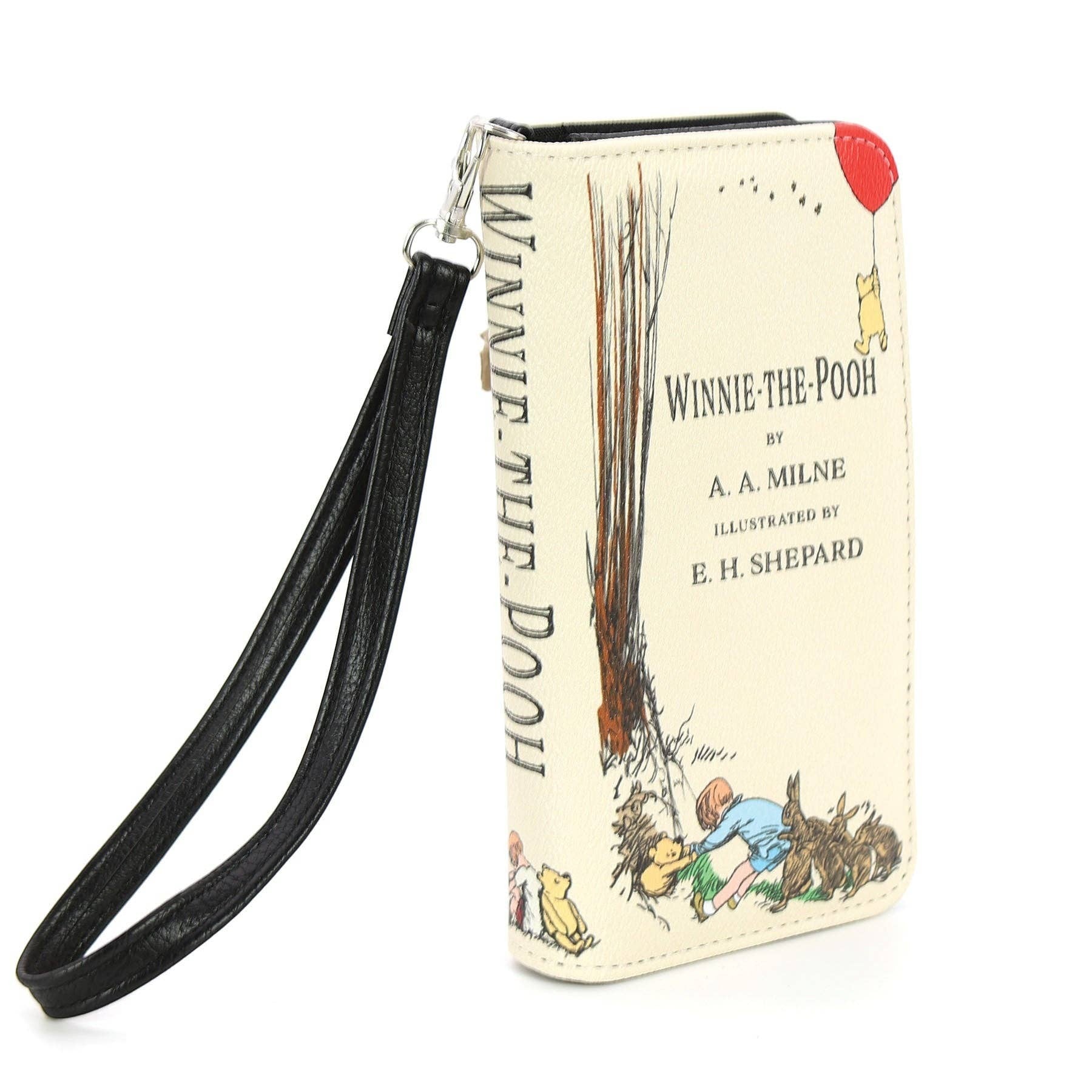 Mellow Monkey Winnie the Pooh beige vinyl book wallet with wristlet strap and classic storybook cover illustration.