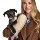 Mellow Monkey winter white Polar Plush mittens with chevron pattern held by a smiling woman holding a small dog.