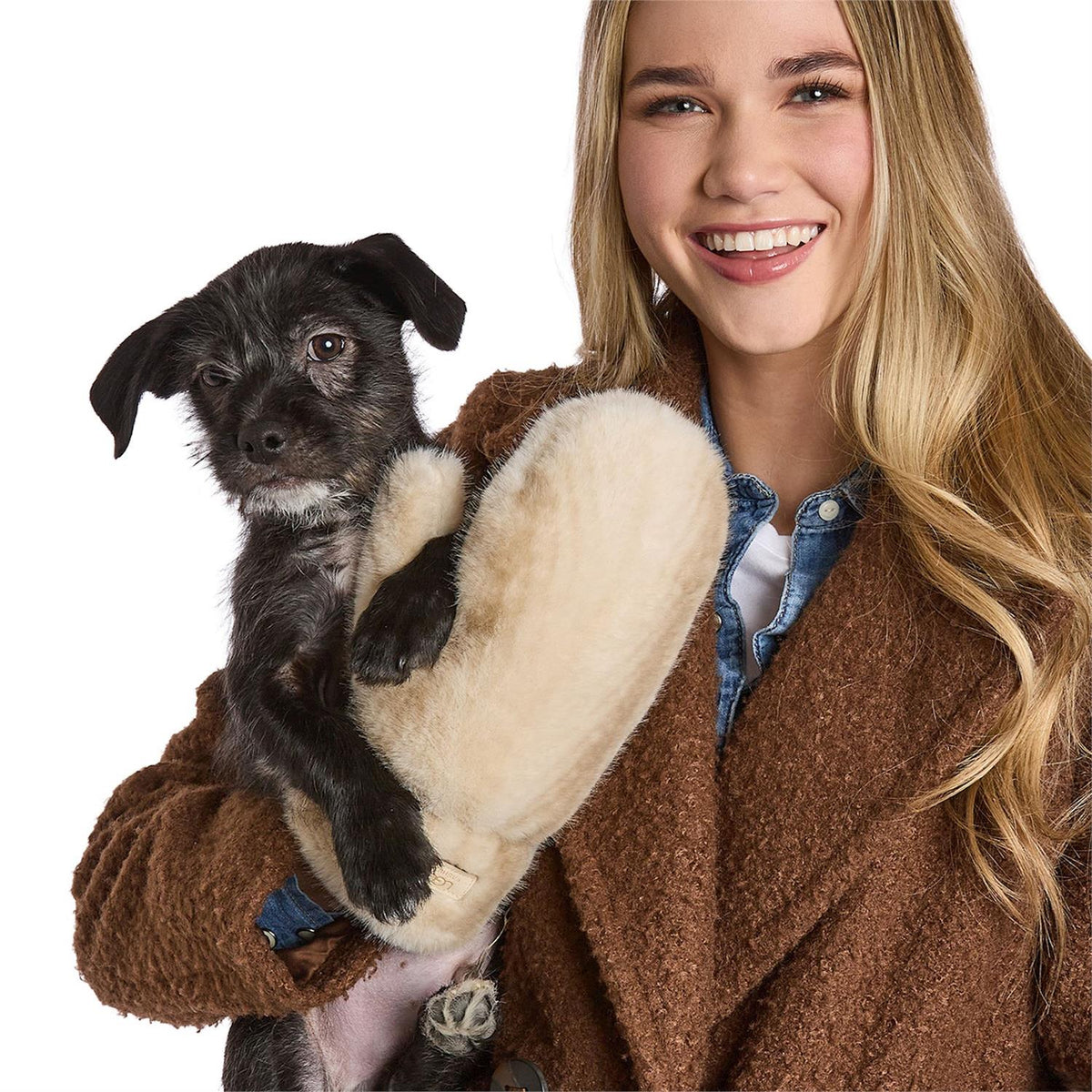 Mellow Monkey winter white Polar Plush mittens with chevron pattern held by a smiling woman holding a small dog.