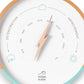 Mellow Monkey white and turquoise wood barometer with a lightning bolt hand, measures atmospheric pressure for weather forecasting.