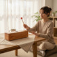 Mellow Monkey wooden tongue drum with mallet on a table, woman playing it.