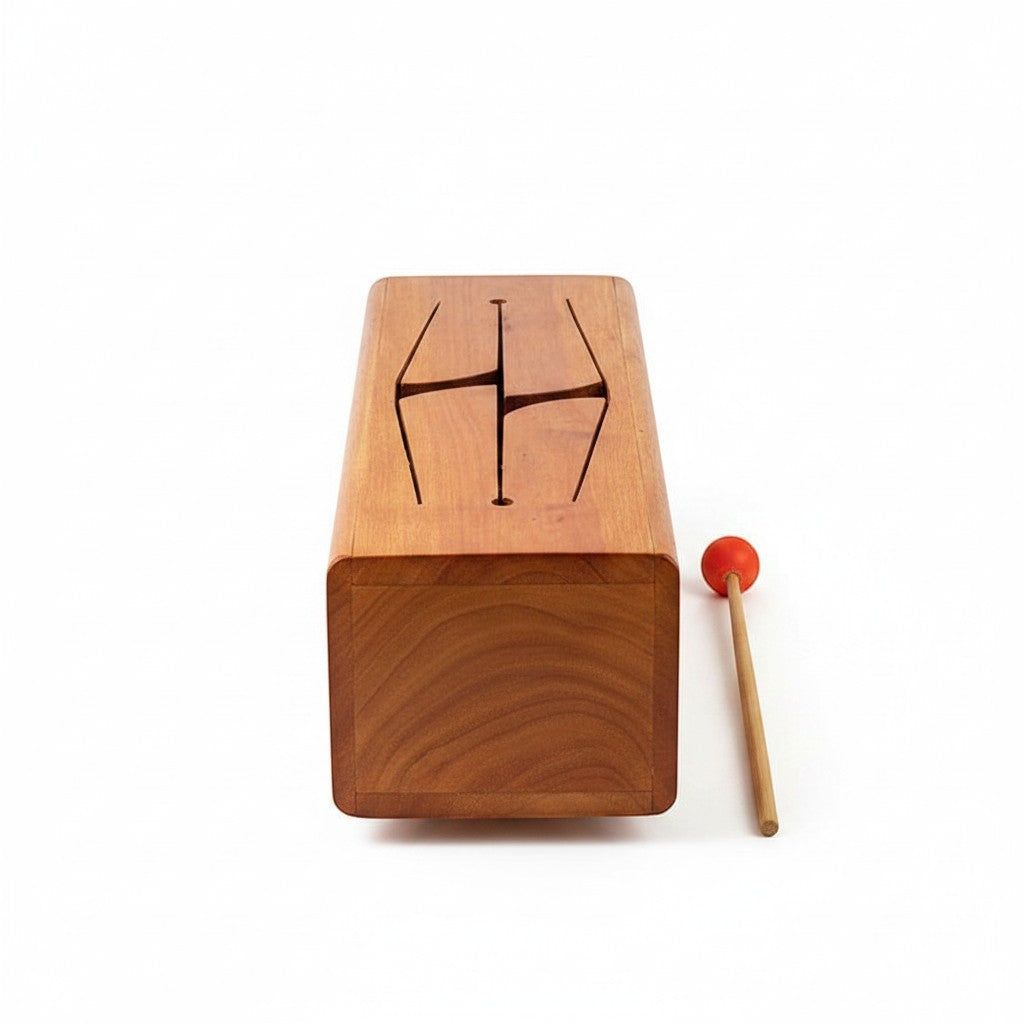 Mellow Monkey wooden tongue drum with carved top and red mallet on white background