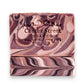 Mellow Monkey Woods vegan handmade bar soap, 4-oz, with mahogany, cedarwood, and oakwood notes. Swirled brown and tan.