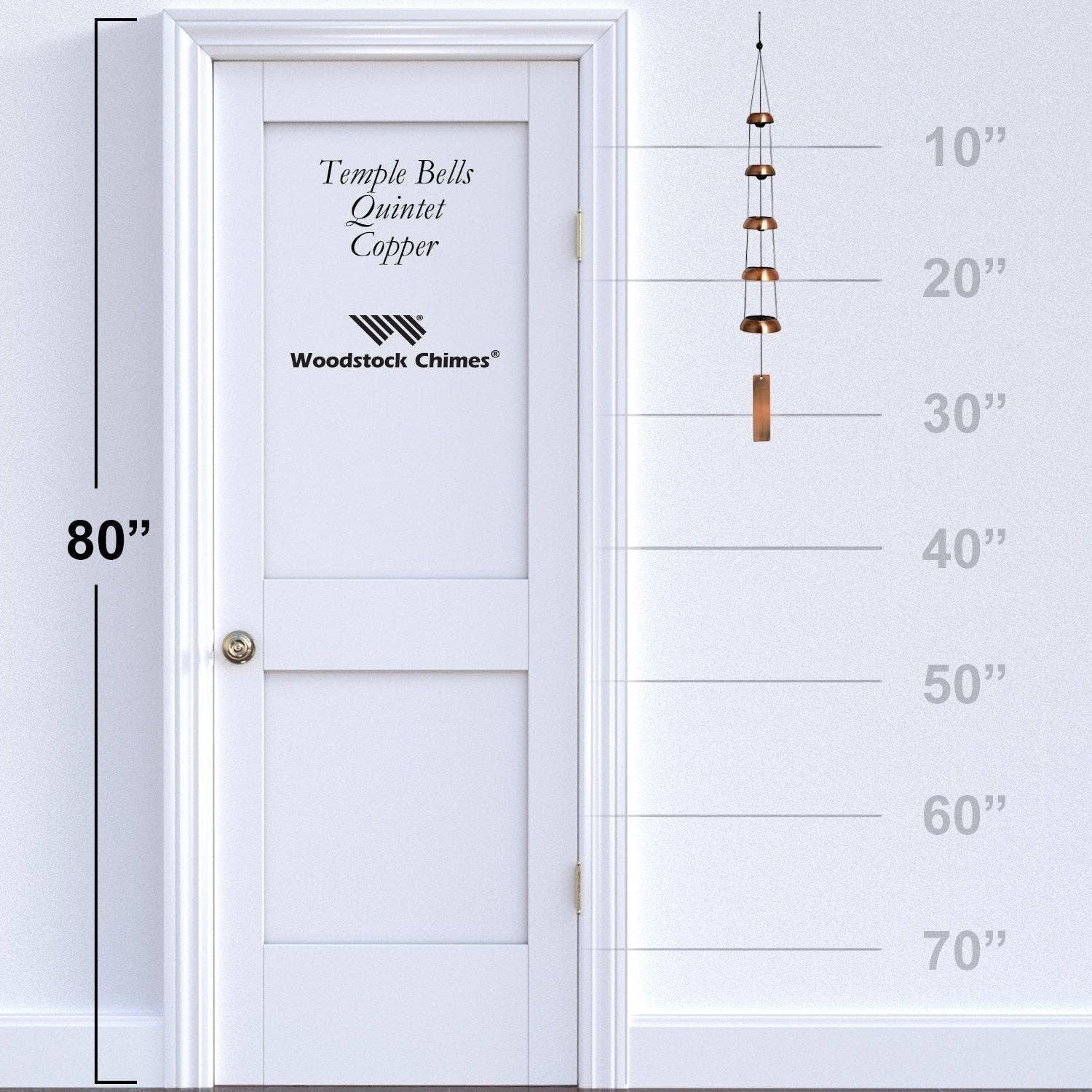Mellow Monkey Woodstock Temple Bells Quintet in copper hanging against a white door with a height measurement scale