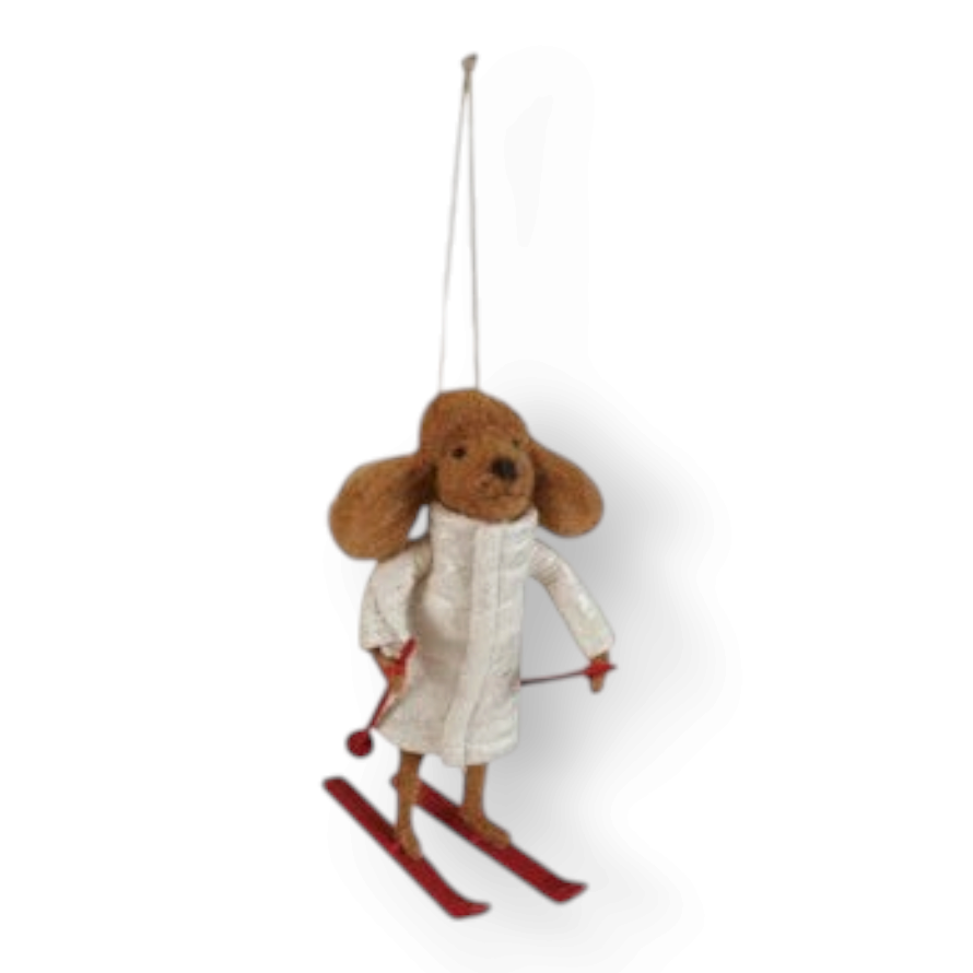Mellow Monkey handcrafted wool felt dog ornament wearing a white quilted coat and red skis for winter decor.