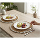 Mellow Monkey woven round placemat with natural straw and white clam rose shell edge, 13-inch diameter.