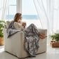 Mellow Monkey woven cotton blend throw blanket with blue and red block pattern and fringe on two edges.