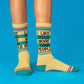 Mellow Monkey yellow gym crew socks with I Like Dogs More Than People text and teal and pink striped accents