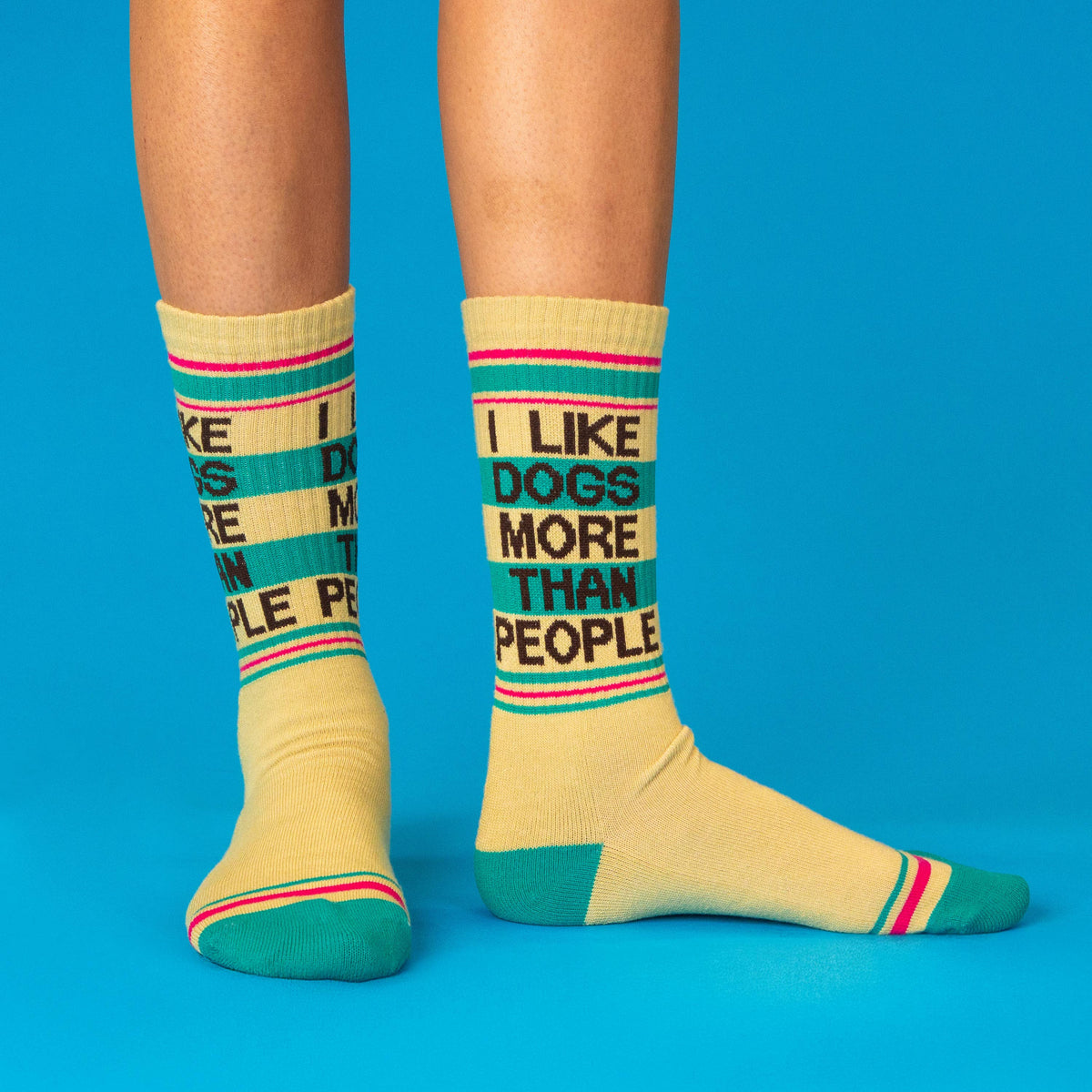 Mellow Monkey yellow gym crew socks with I Like Dogs More Than People text and teal and pink striped accents