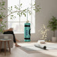 Mellow Monkey teal blown glass yoga mat ornament with black accents and "YOGA" text. Holiday decor.