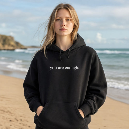 Mellow Monkey black unisex hoodie with "you are enough." printed on the front. Soft & durable.