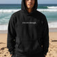 Mellow Monkey black unisex hoodie with "you are enough." printed on the front. Soft and durable.