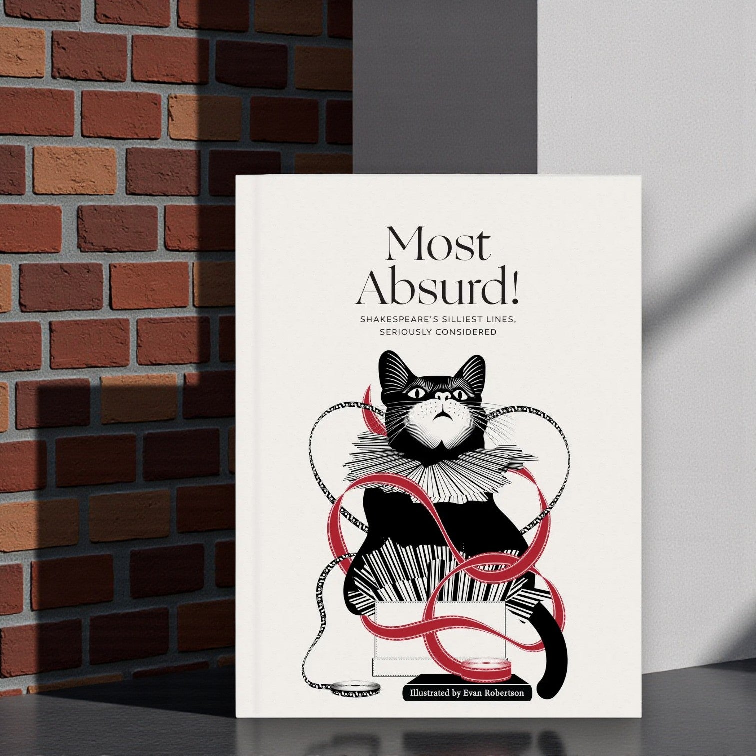 Book cover with illustration of a cat and text about Shakespeare's lines
in front of a red brick wall